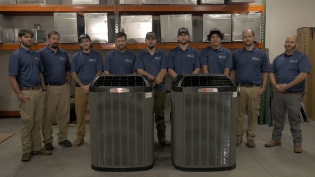 Team infront of ac units