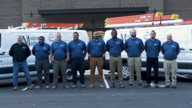 Team photo infront of vans