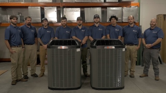 Team infront of ac units
