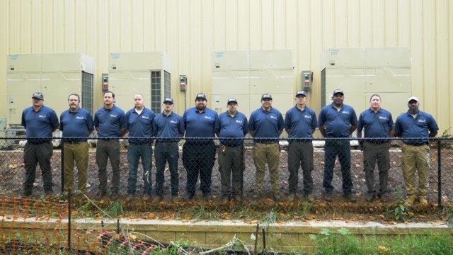 Team photo behind fence